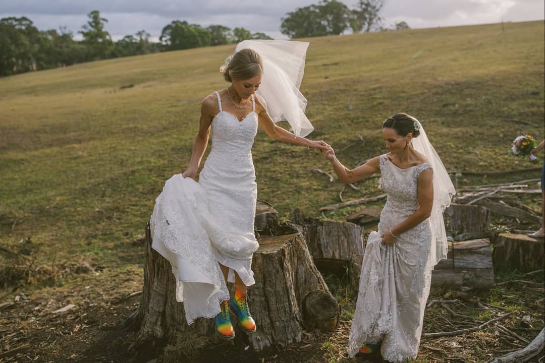wives holding hands in moss vale farm wedding venue